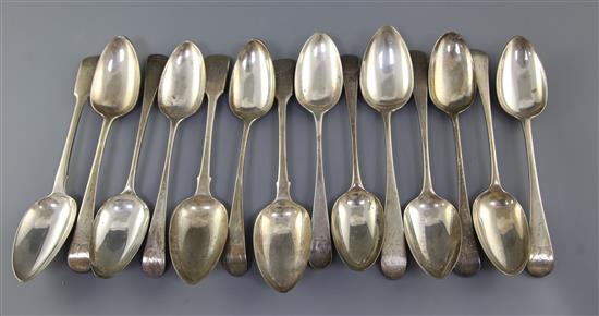 Fourteen assorted George III silver table spoons, 30 oz.